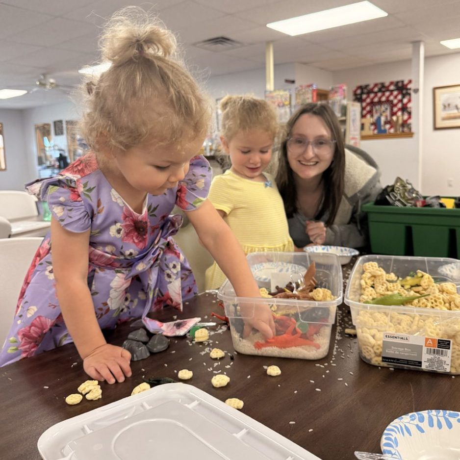 Ellisynn Lopez (left) and Willow Clark (middle) enjoying “ToddlerTime” with Circulation Clerk Haylee Duron.